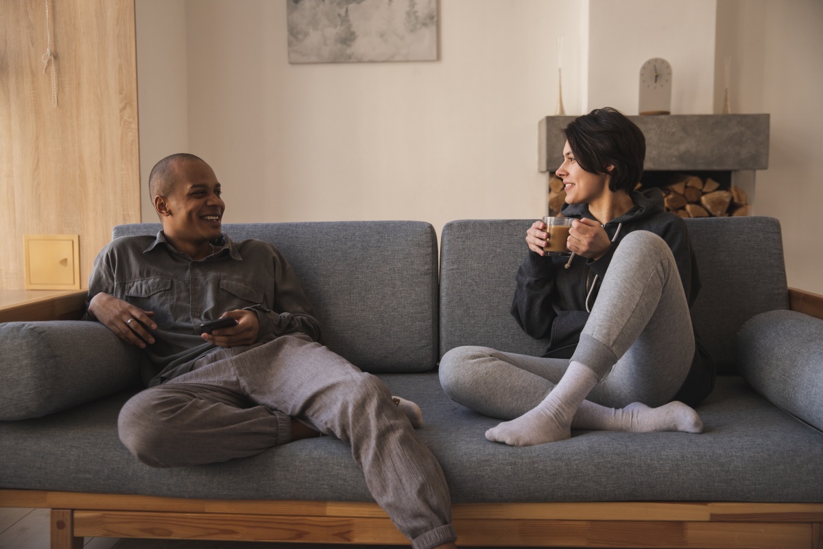 Two people talking on a sofa