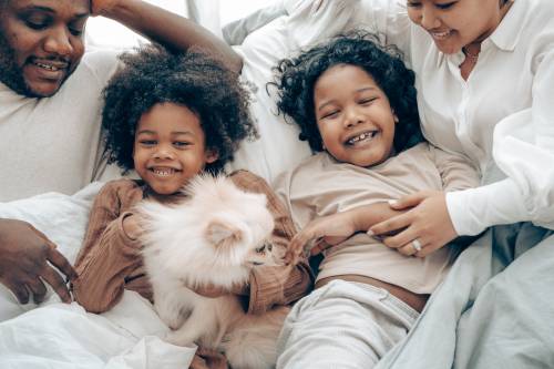 A family in bed with their dog