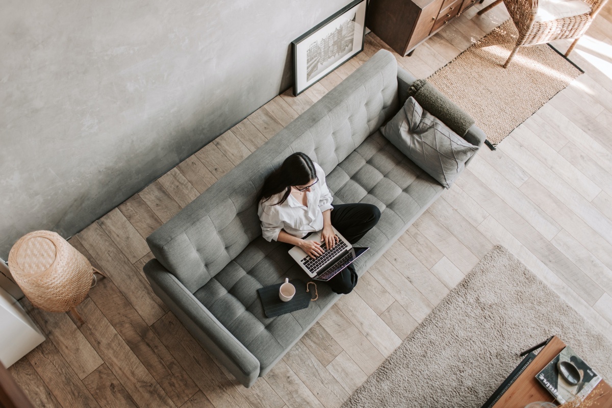 Woman sitting on a grey sofa